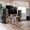 A living room loft equipped with Sonus faber Lumina floorstanding and center channel speakers placed around a TV.