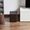 A Sonus faber Gravis I subwoofer placed next to Sonetto speakers on a living room floor.