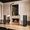 Diffusori Sonus faber Amati della collezione Homage in legno grafite accanto a un camino in marmo.